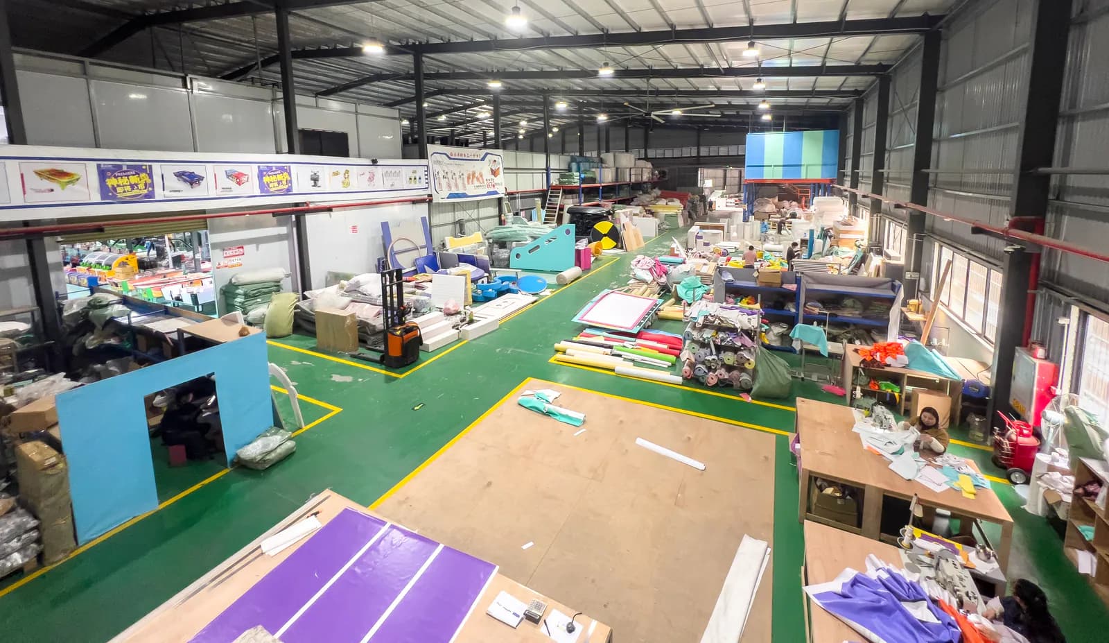 Production tables and material areas inside the indoor playground workshop