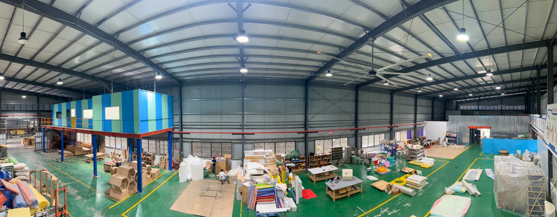 Wide view of an indoor playground production workshop